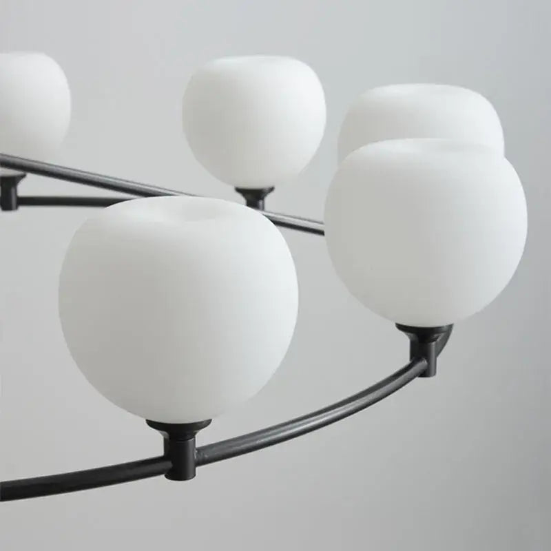 Modern black pendant lamp with matte metal arms and white glass pendant shades for dining room lighting
