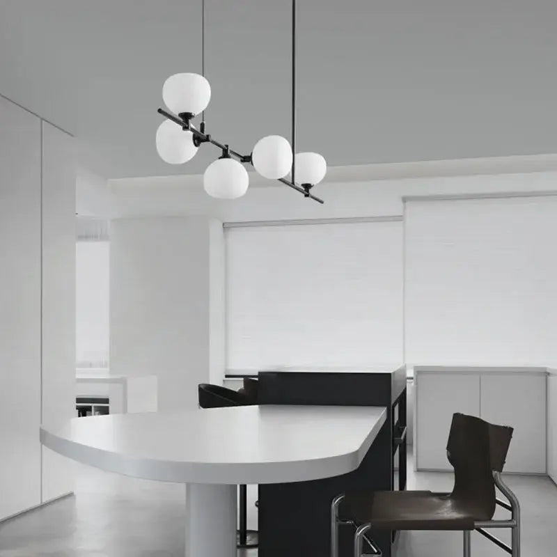 Modern black metal pendant lamp with five frosted white glass globes for dining room lighting