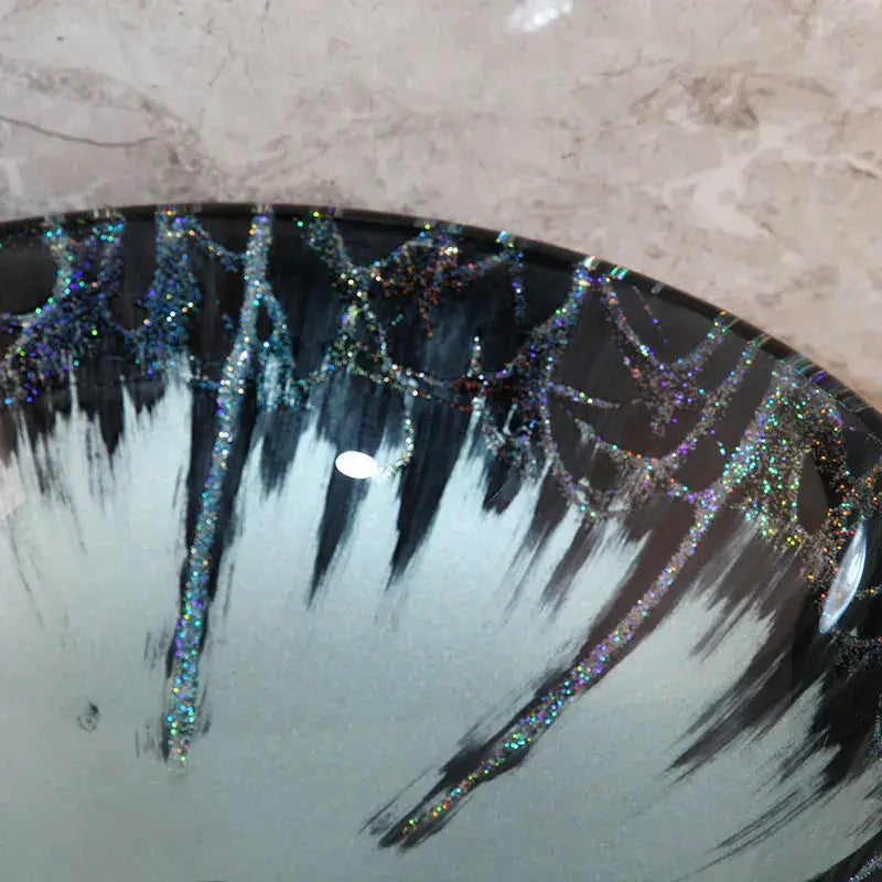 Glossy black and white ceramic basin tap set with iridescent glittery web patterns for modern bathroom sink