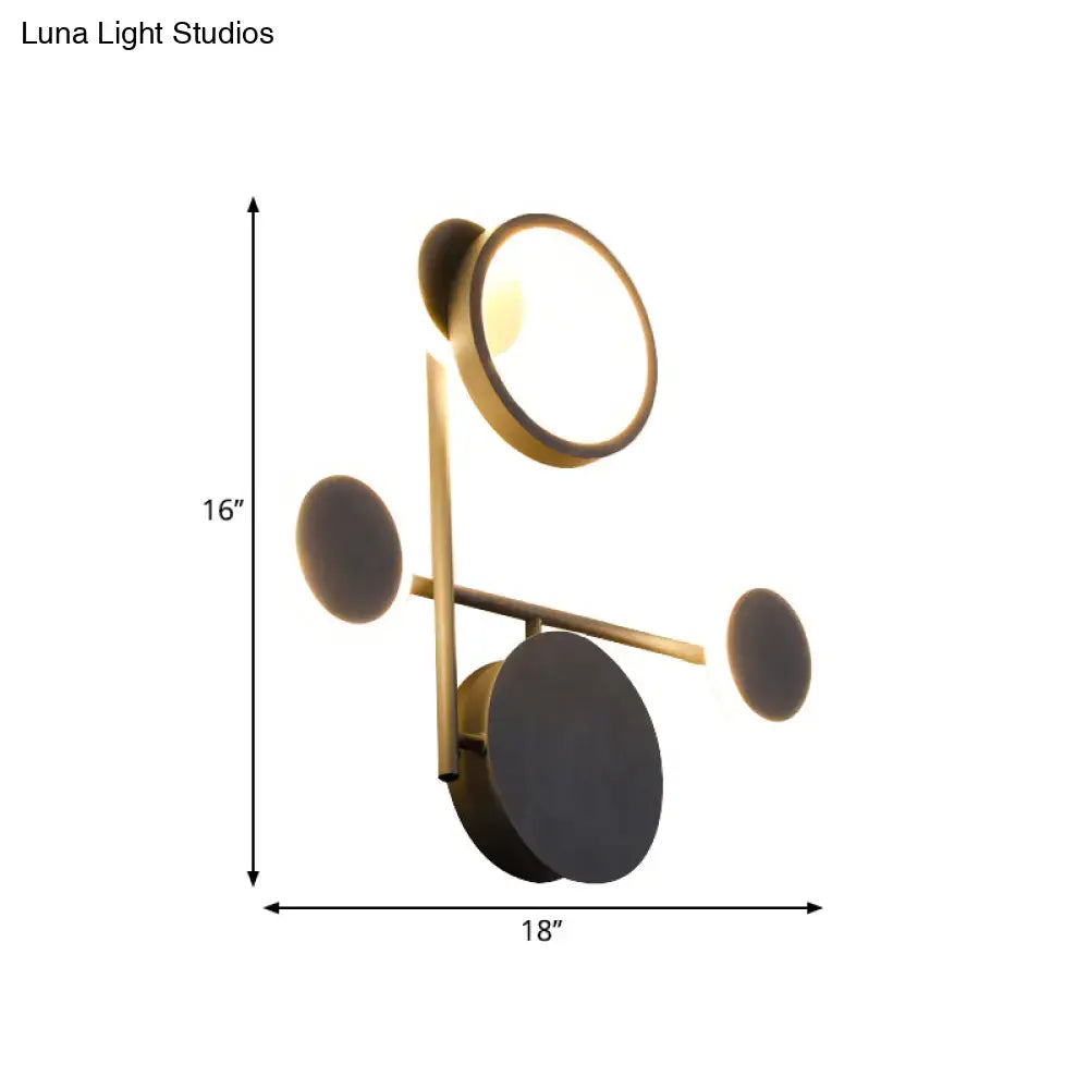Modern black and white metallic round led wall sconce with gold-toned circular light fixtures and matte black accents