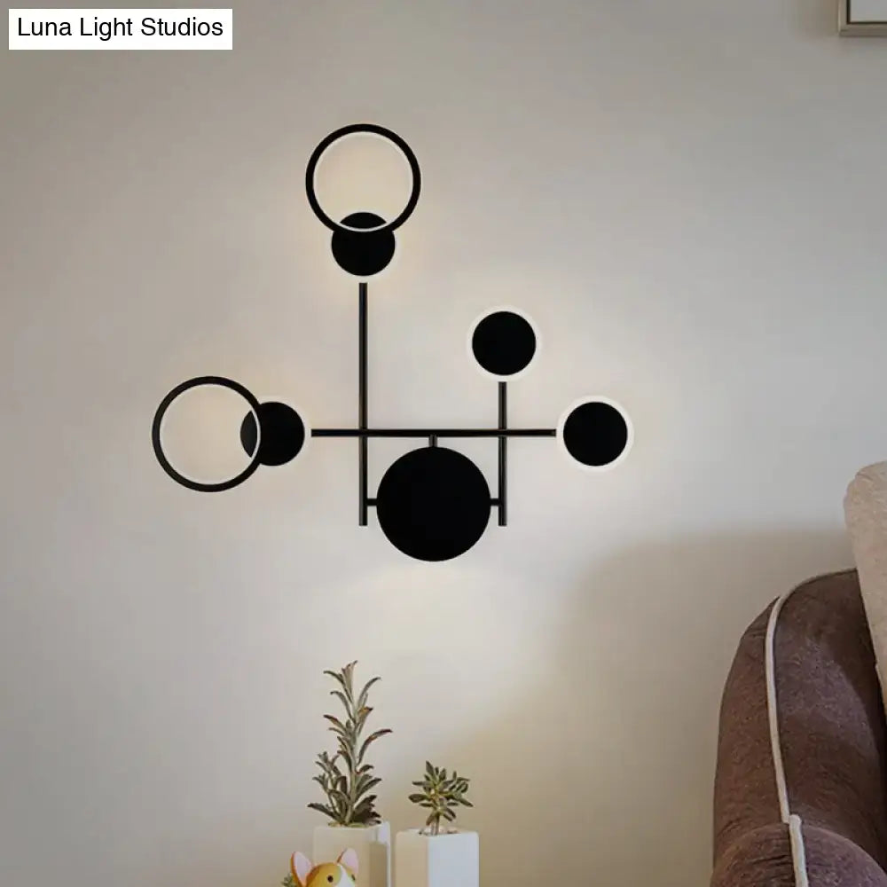 Modern black and white metallic round led wall sconce with circular ring-shaped light fixtures for living room use