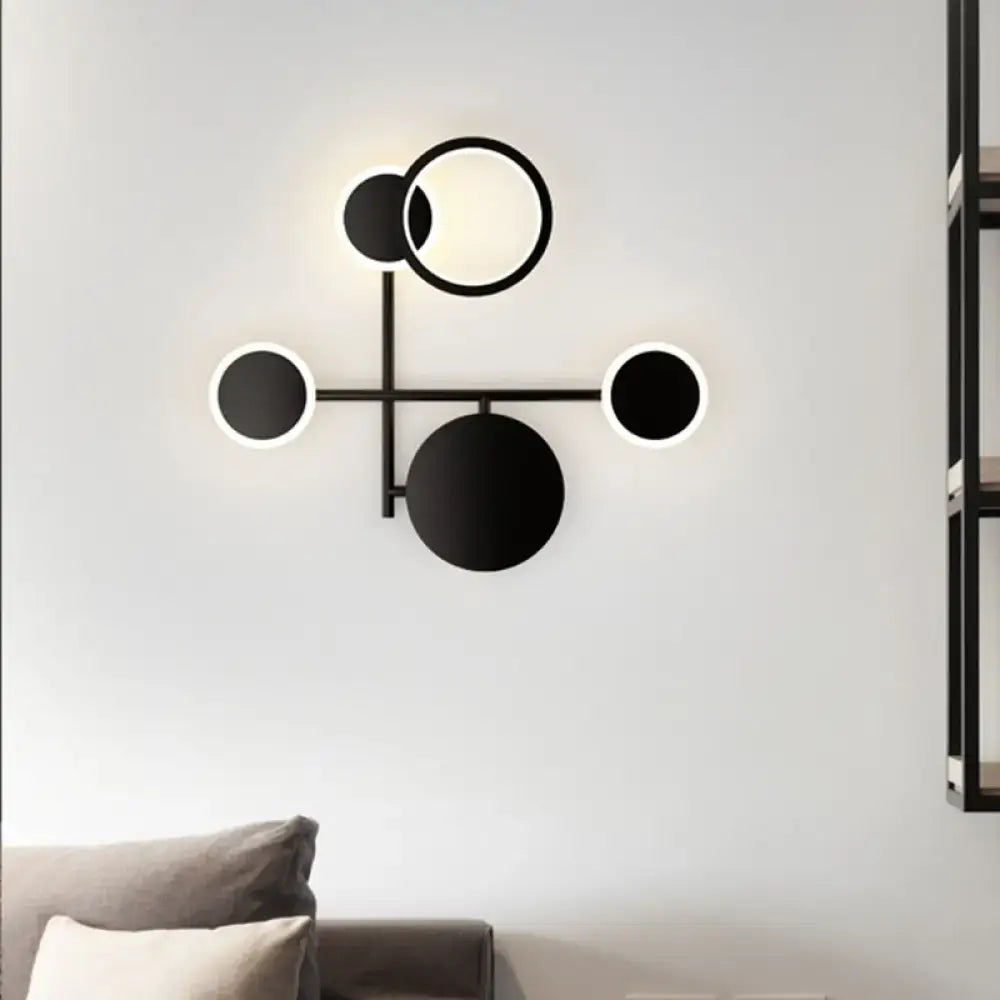Modern black and white metallic round led wall sconce with glowing led rings for living room lighting