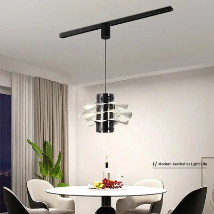 Modern black and white petal pendant lamp with sleek cylindrical body and wave-like arms for decorbites designer restaurant