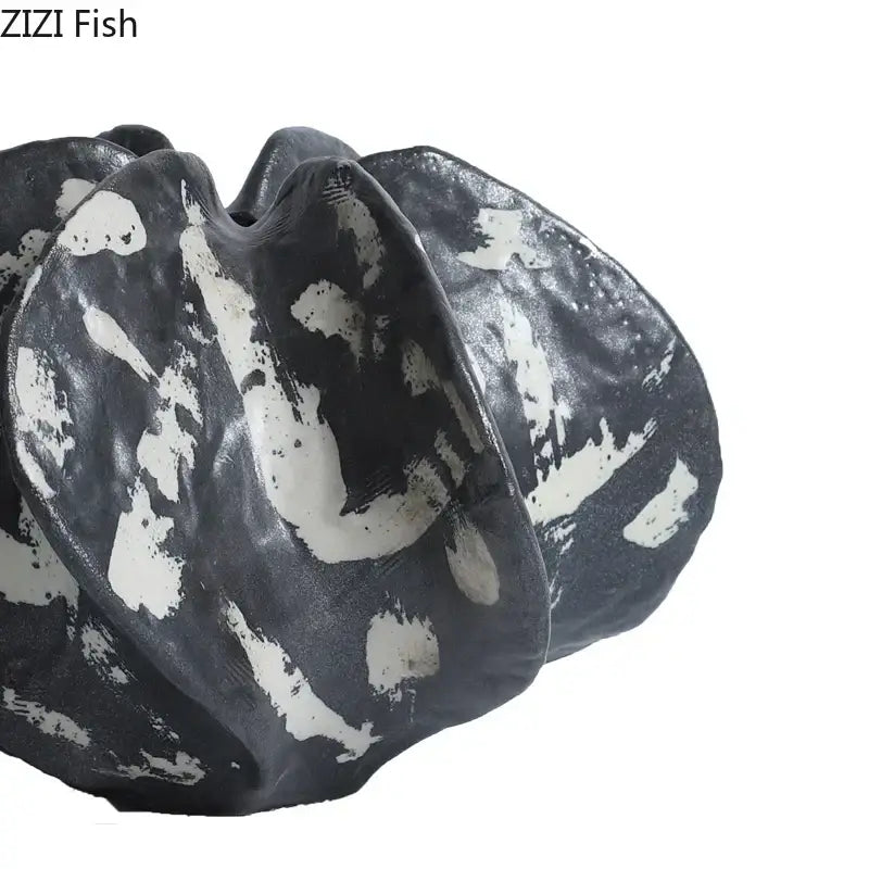 Modern black and white ceramic starfruit coral sculpture with organic shell-like folds for bedroom decor