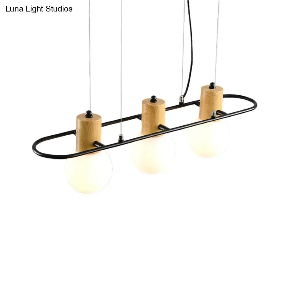 DecorBites black orb island pendant light with frosted glass hanging bulbs and natural wood cylinder accents in black metal frame