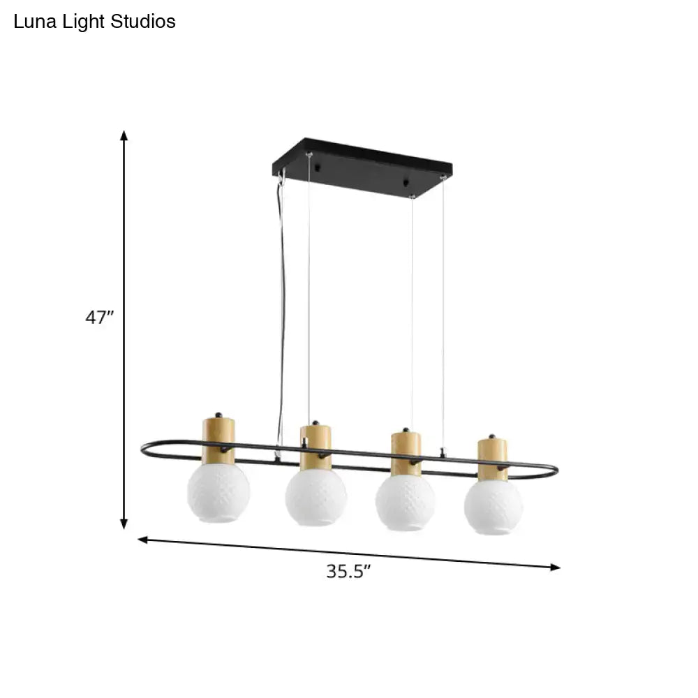 Modern black orb island pendant light with wood tones and four frosted glass hanging globe bulbs for kitchen island lighting