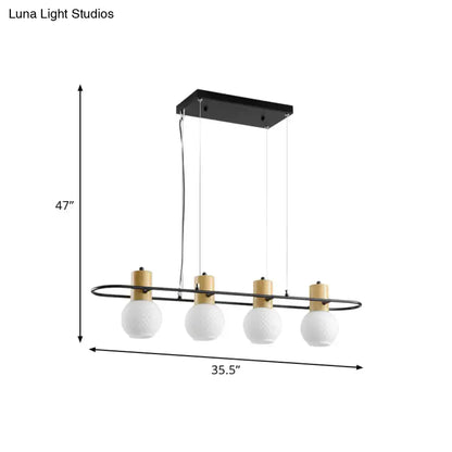 Modern black orb island pendant light with wood tones and four frosted glass hanging globe bulbs for kitchen island lighting
