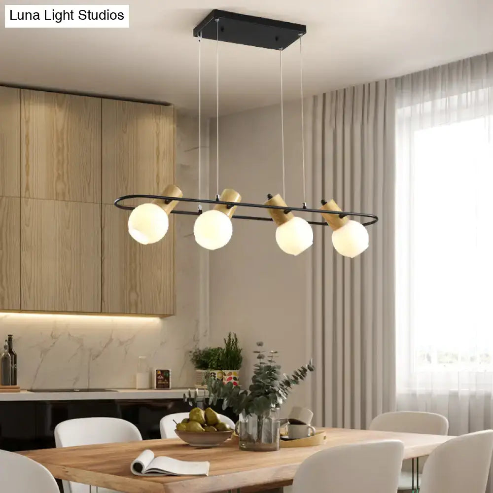 Modern DecorBites black orb island pendant light with black metal, wood accents, and frosted glass hanging globes