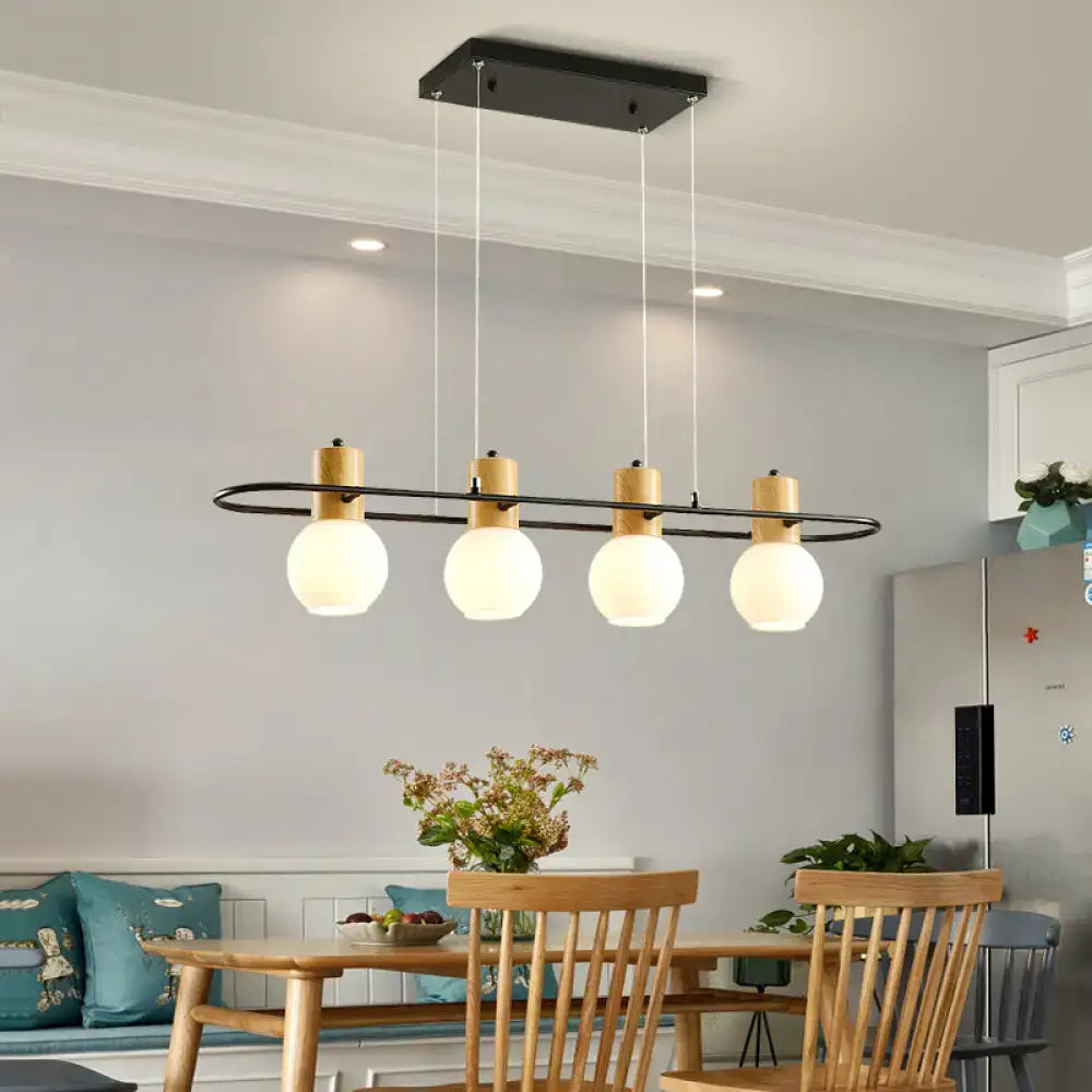 Modern black orb island pendant light with frosted glass hanging globes and wooden accents for interior decor