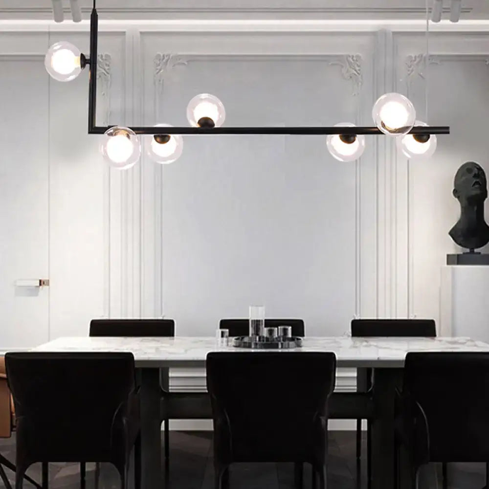 Modern black metal angle arm chandelier with spherical glass globes for kitchen island lighting