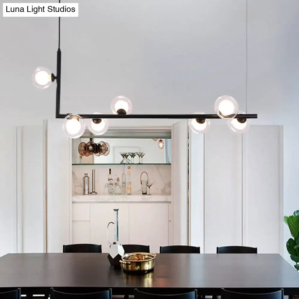 Modern black angle arm chandelier with clear glass globe bulbs designed as a kitchen island pendant light