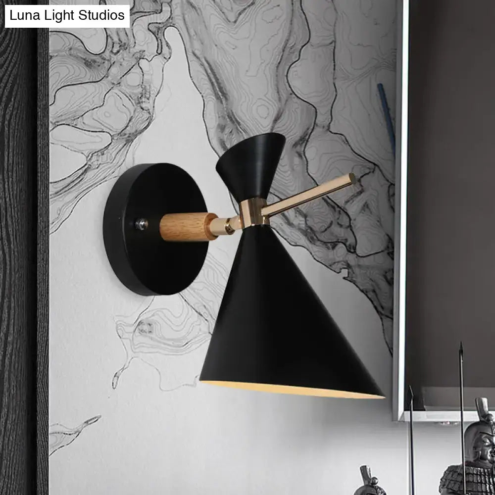 Modern black angle shade wall sconce with matte finish, circular wooden base, and brass accents for bedroom lighting