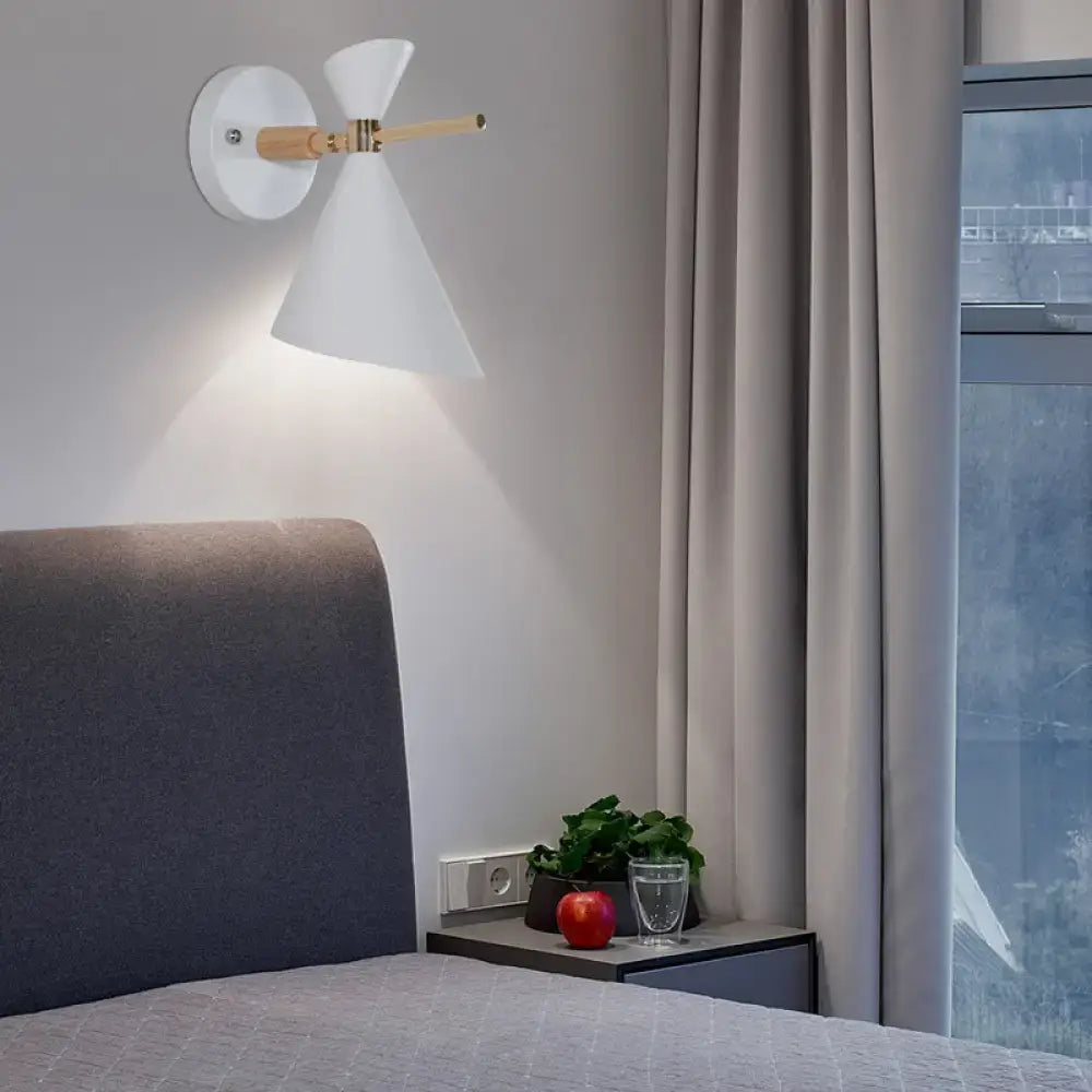 Modern white conical wall sconce with wooden accent arm and black angle shade ideal for bedroom lighting