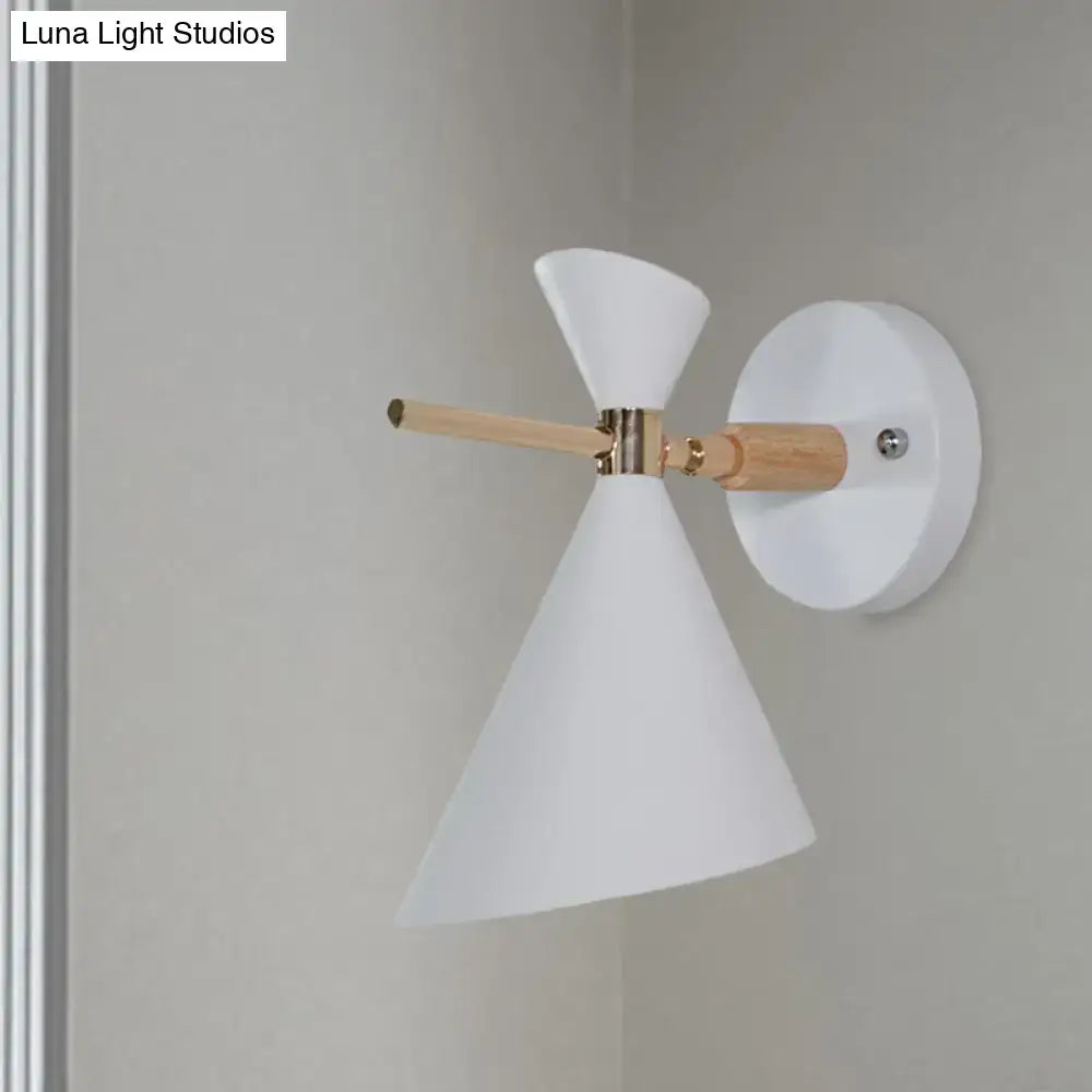 White conical wall sconce with wooden arm and brass accents featuring modern black angle shade for bedroom lighting