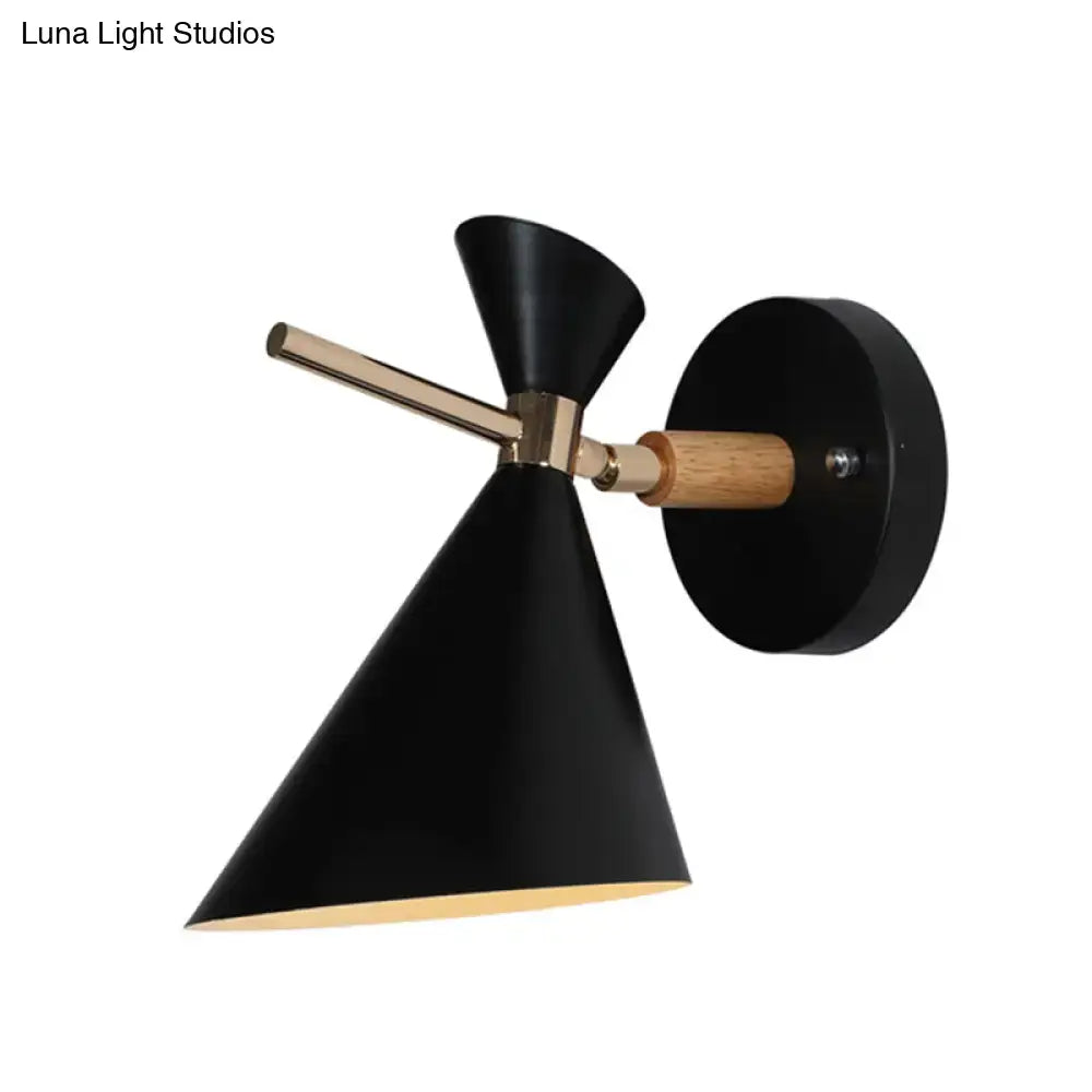 Modern black wall sconce with conical angle shade, brass accent, and wooden handle for bedroom lighting