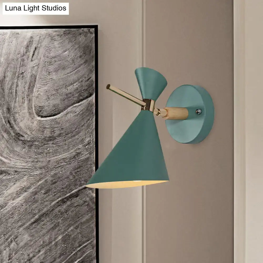 Modern wall sconce with teal conical angle shade, brass-finished arm, and wooden accent for bedroom lighting