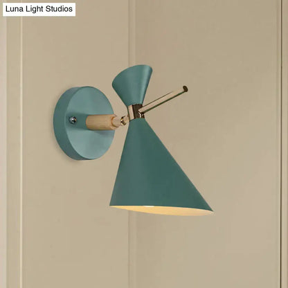 Teal wall sconce with wooden arm and conical angle shade designed as a modern bedroom light fixture