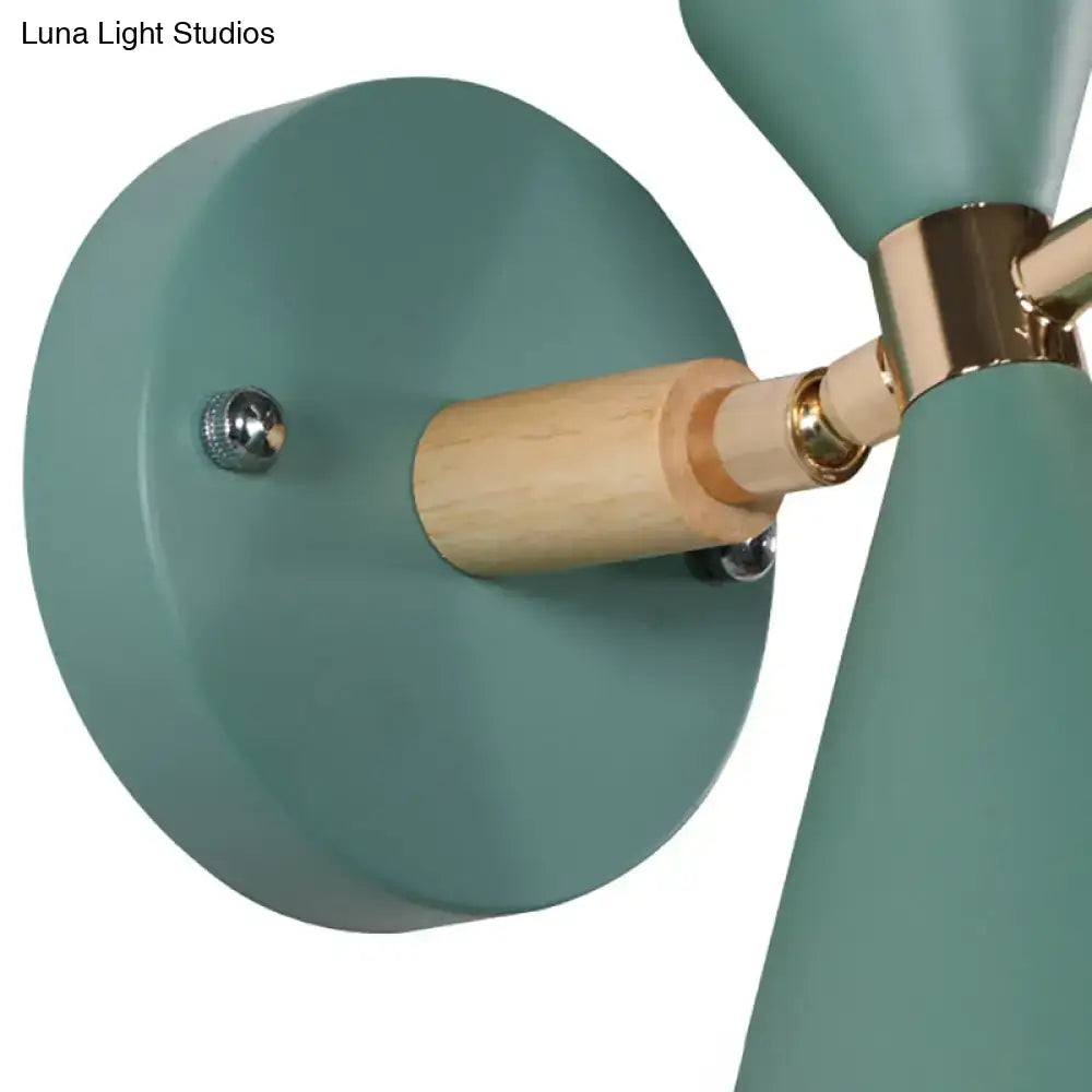 Modern teal matte-finished wall sconce with wooden dowel and brass accents featuring an angle shade for bedroom lighting