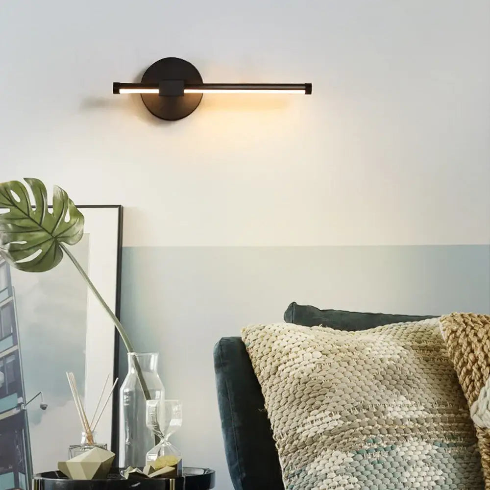 Modern black angular indoor led wall light with sleek horizontal bar and circular base for bedroom decorbites indoor led use