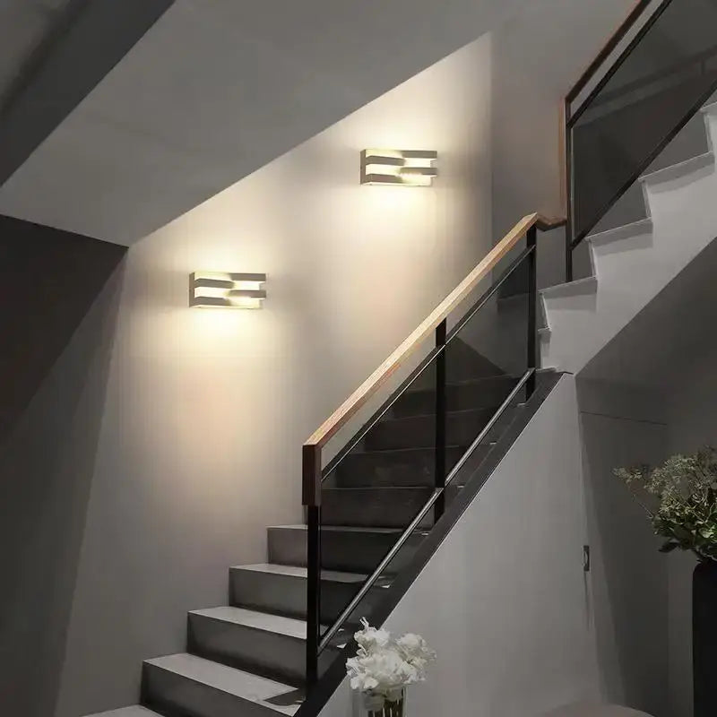 Modern black angular metal ip65 outdoor wall lamp with sleek metallic finish and warm diffused lighting for villa porch