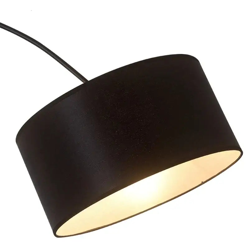 Modern black arched led floor lamp with a black cylindrical fabric shade featuring a matte finish and warm interior lining