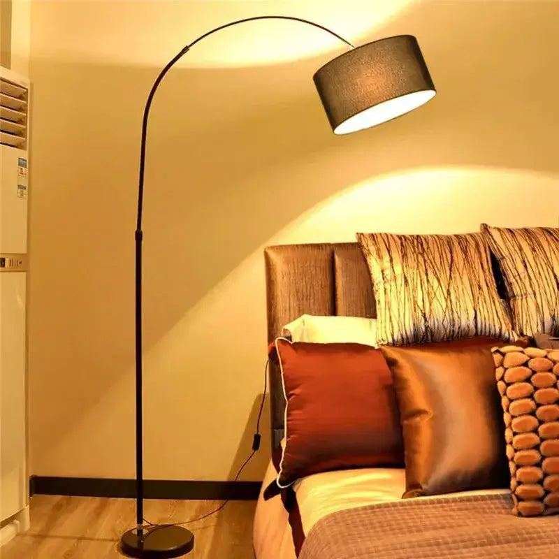 Modern black arched led floor lamp with textured gray fabric drum shade for living room lighting