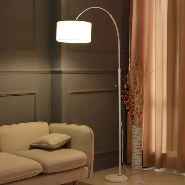 Modern black arched led floor lamp with white fabric shade and sleek curved metal frame for living room use