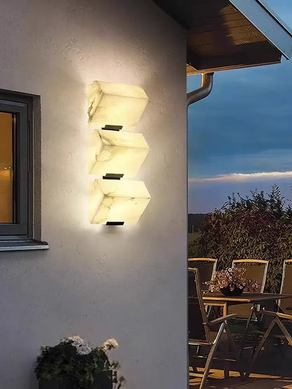 Modern black art deco marble led wall light with three warm glowing white marble panels for bedroom decorbites art deco