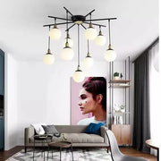 Modern black metal chandelier featuring multiple frosted art glass ball globe bulbs for living room decorbites art glass