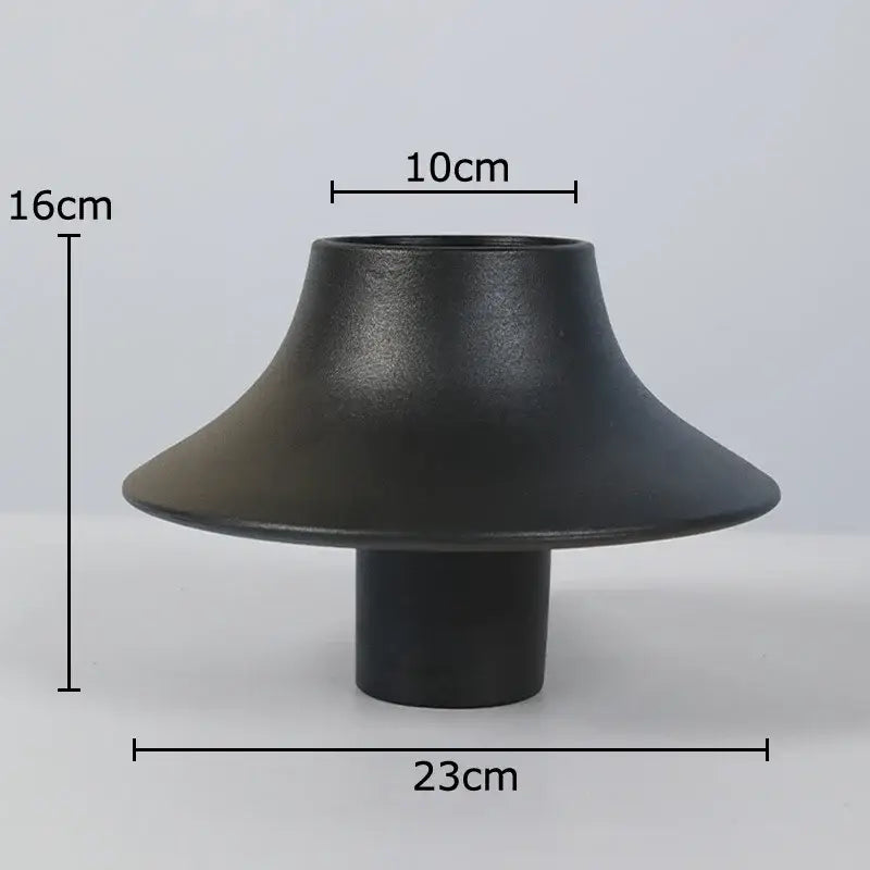Modern black bell shaped decorbites ceramic vase with flared rim and cylindrical base for stylish desktop decor