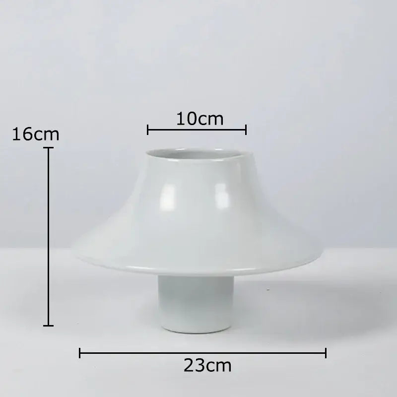 A sleek glossy white decorbites ceramic vase with flared bell-shaped top and cylindrical base for modern desktop decor