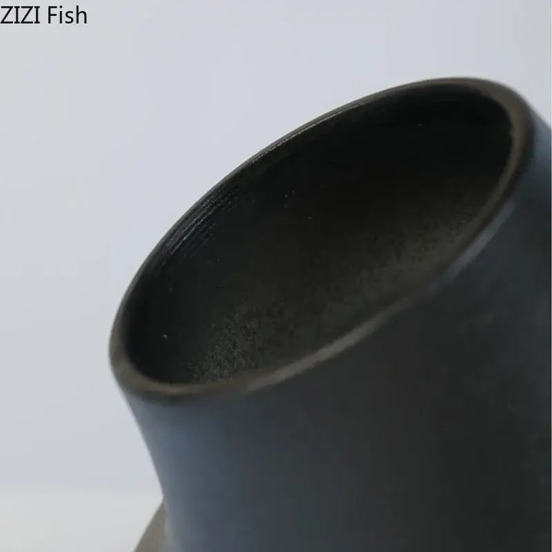 Modern black bell shaped decorbites ceramic vase with smooth matte finish and flared rim for desktop decor