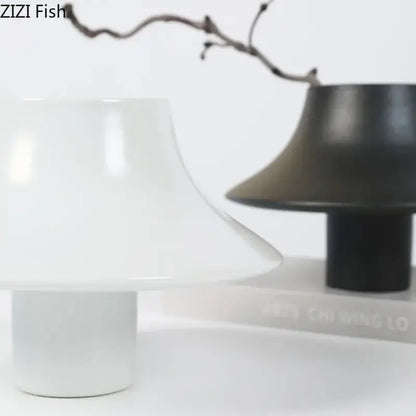 Modern black bell shaped decorbites ceramic vase with white flared mushroom top and cylindrical base for desktop decor