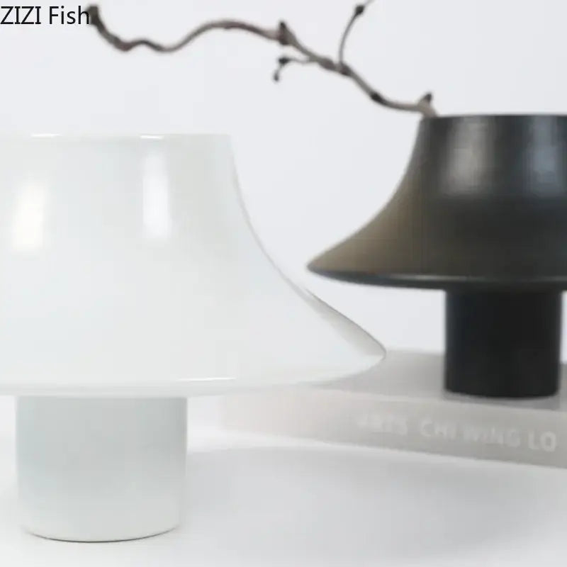Modern black bell shaped decorbites ceramic vase with white flared mushroom top and cylindrical base for desktop decor