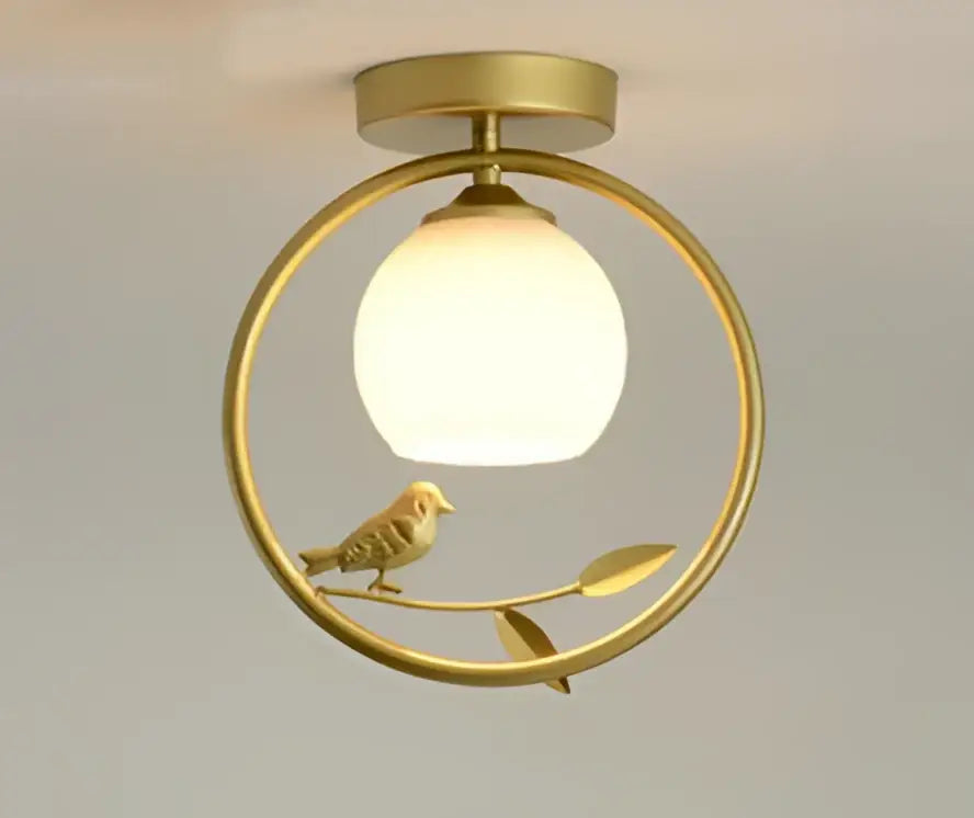 Modern black bird ceiling light fixture with a gold-toned circular frame and frosted glass globe for corridor entrance