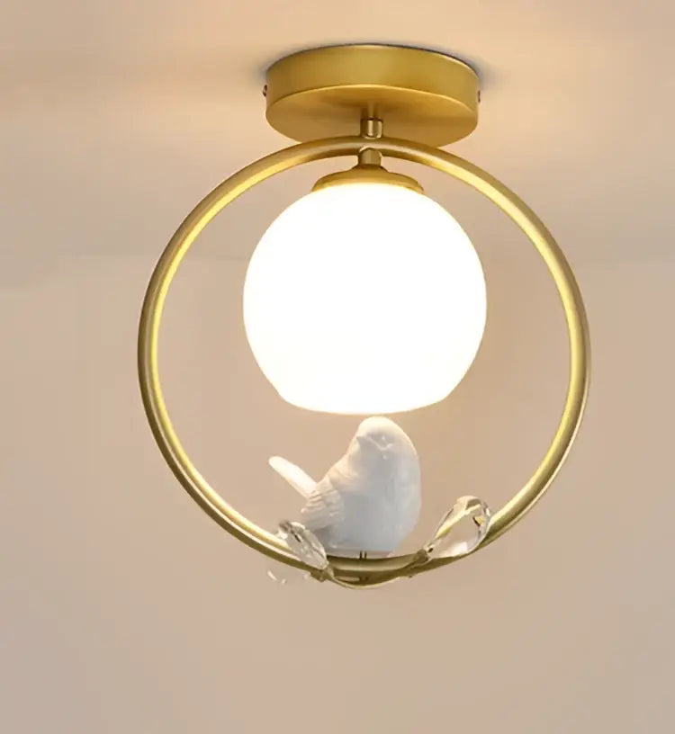 Modern black bird ceiling light fixture with gold-toned frame, spherical glass bulb, and white ceramic bird for corridor use