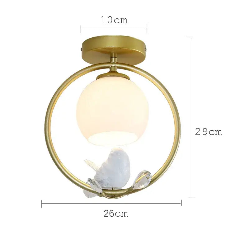 Modern black bird ceiling light fixture with gold-toned circular frame frosted globe and white ceramic bird on crystal accents