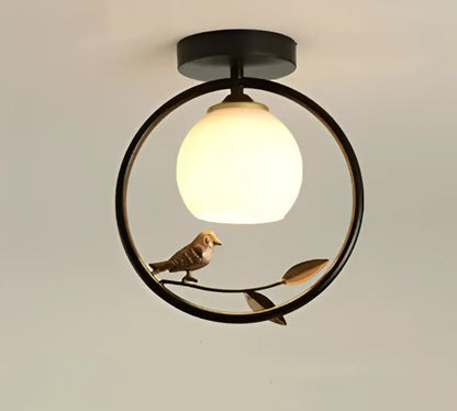 Modern black metal circular ceiling light fixture with warm white globe bulb and bird figurine for corridor entrance