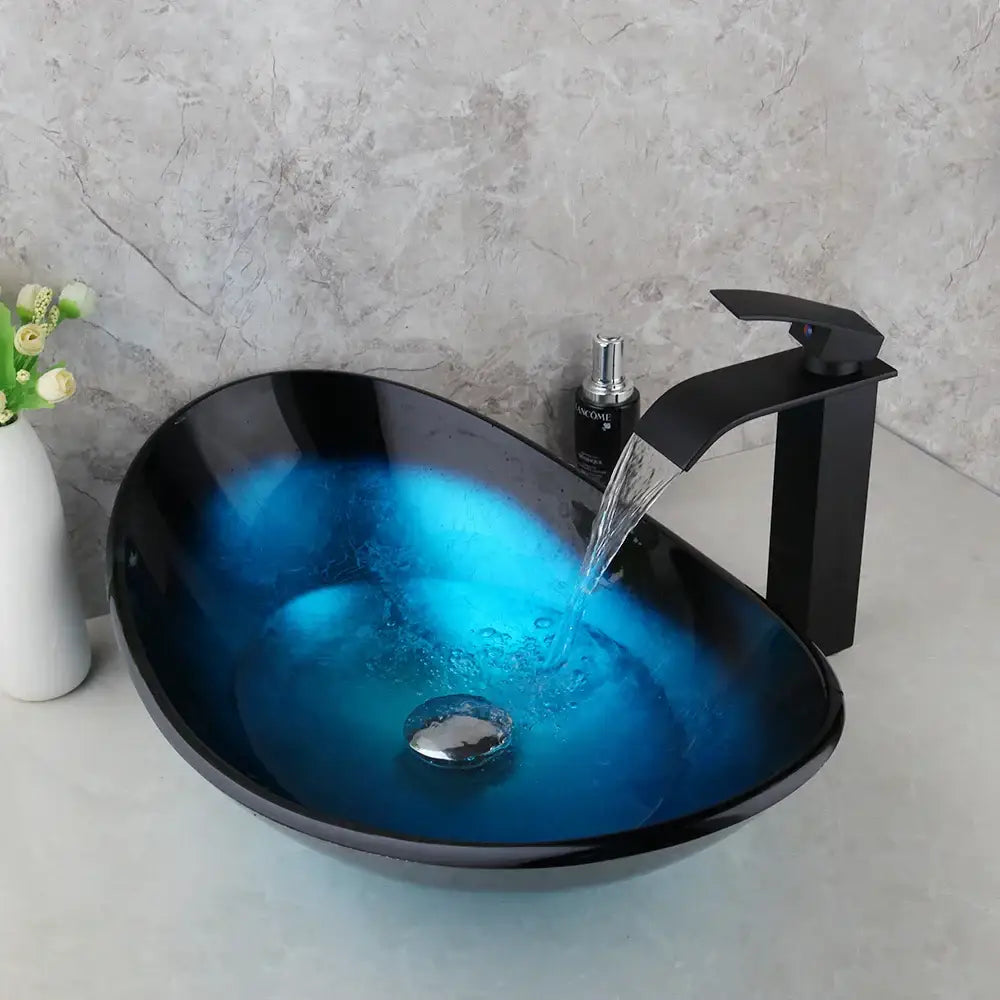 Modern black and blue glass vessel sink basin tap set featuring vibrant blue gradient interior and matching black faucet