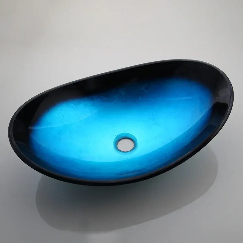 Vibrant blue glass vessel sink with sleek black rim and glossy finish in modern basin tap set for bathroom use