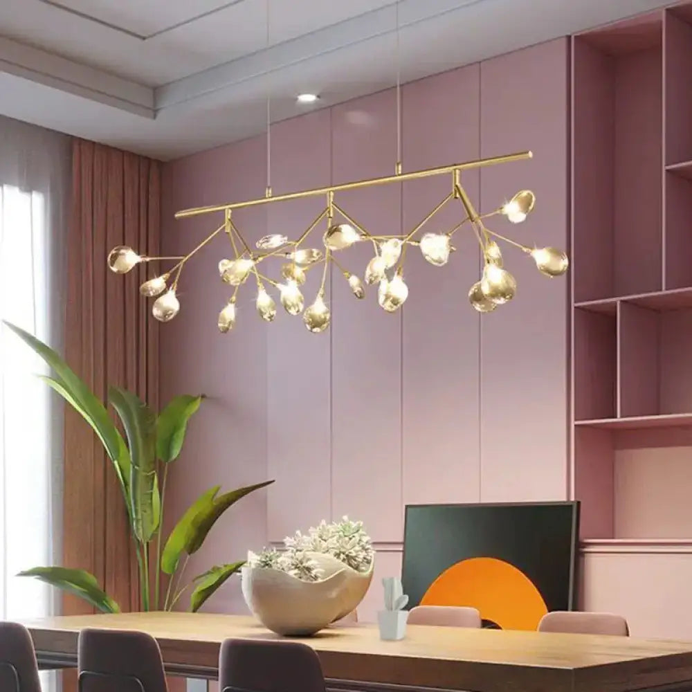 Modern gold-toned branching chandelier with clear glass globe bulbs for dining room lighting