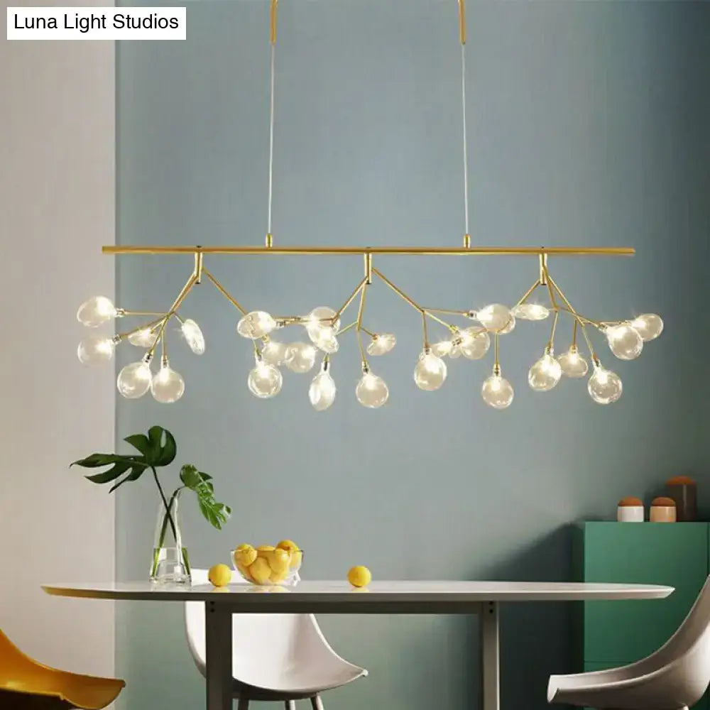 Modern gold-toned pendant light with branching design and clear glass globe bulbs for dining room use
