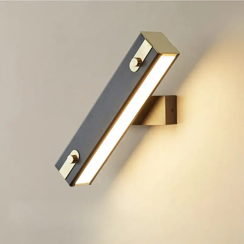 Modern black and brass wall lamp with matte finish and two circular knobs for decorbites adjustable led bedroom sconce