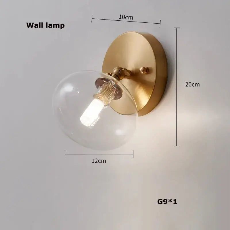 Modern black brass american series wall lamp with gold-toned brass and clear glass globe featuring exposed g9 bulb decorbites black brass