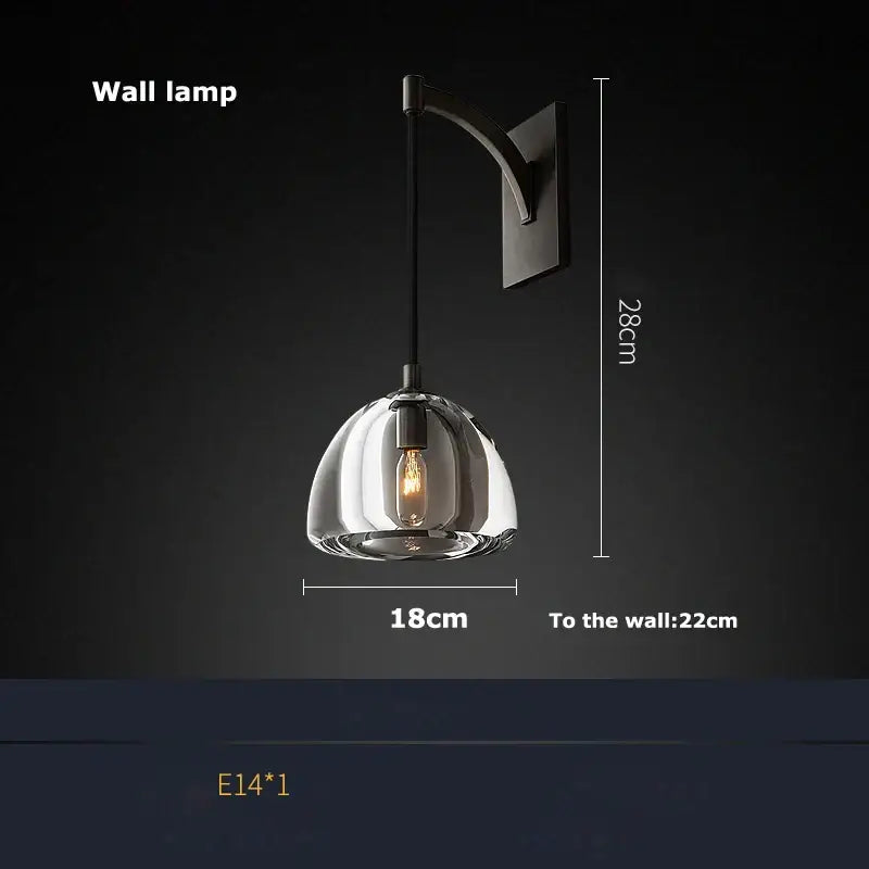 A modern black brass american wall lamp with a clear glass dome and exposed filament bulb for dining room decorbites black brass