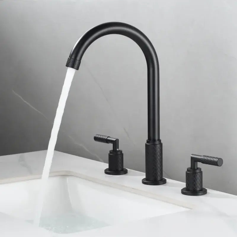 Modern black brass basin faucet with matte finish textured handles and curved spout on white sink decorbites black brass