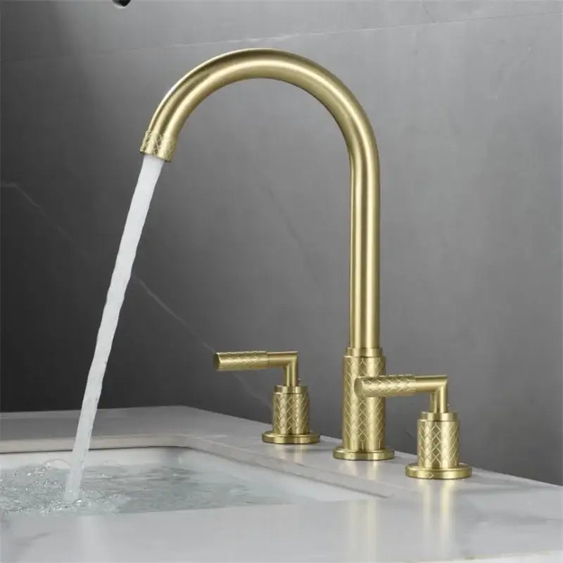 Gold-toned decorbites black brass basin faucet with curved spout and diamond-patterned textured handles for bathroom use