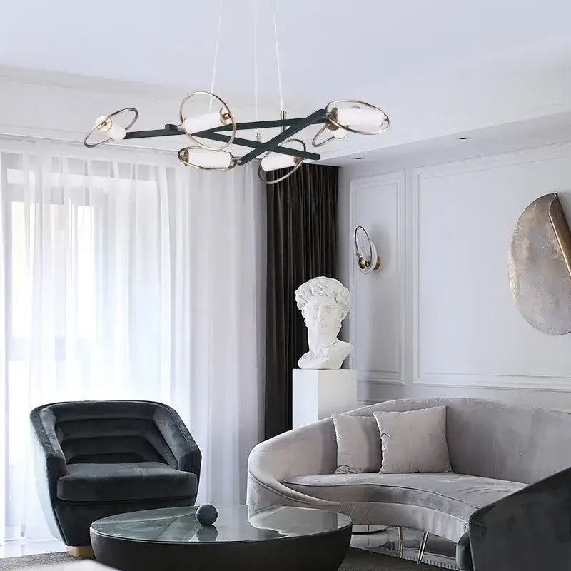 Modern black and brass pendant light with decorbites circular ring design and frosted glass shades for dining room decor