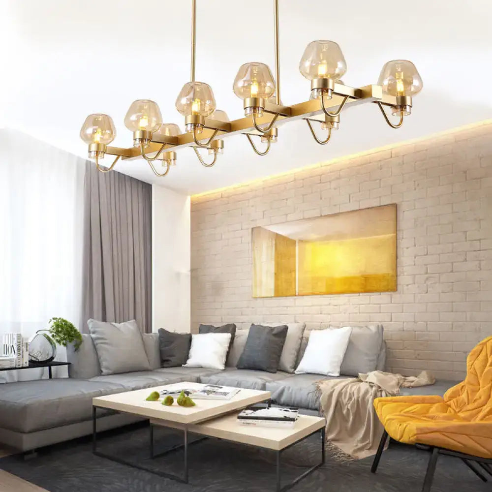 Gold-toned decorbites contemporary island lamp with multiple frosted glass globe shades in clear amber smoke finish