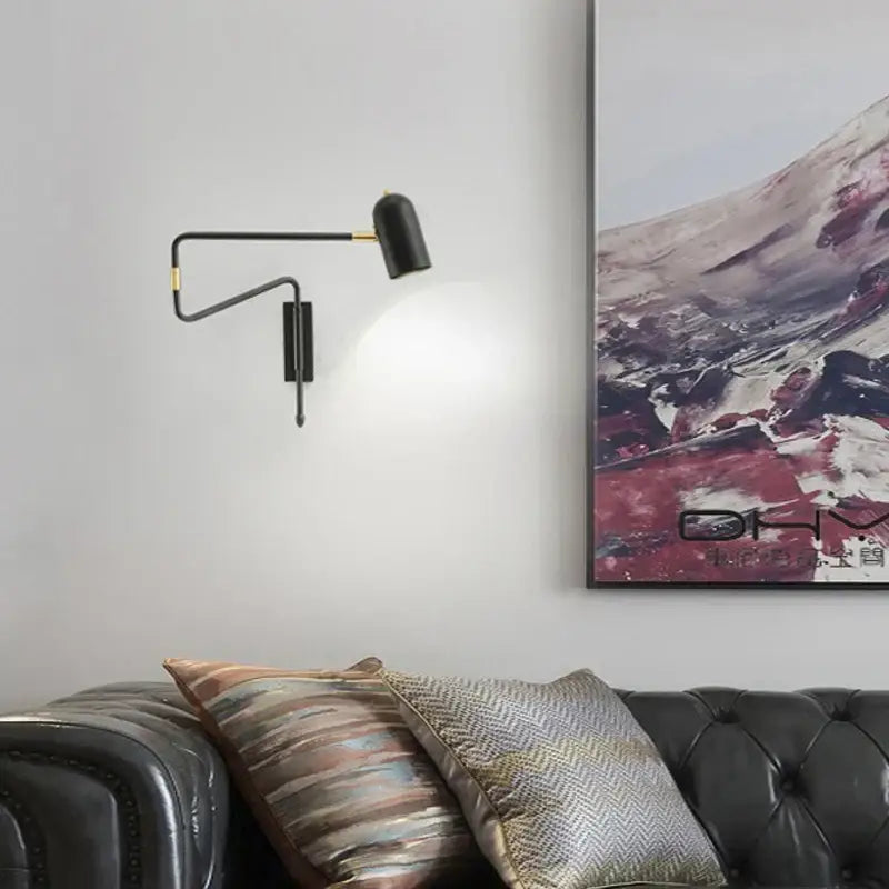 Modern black wall lamp with brass accents featuring decorbites adjustable long-arm design for bedroom use